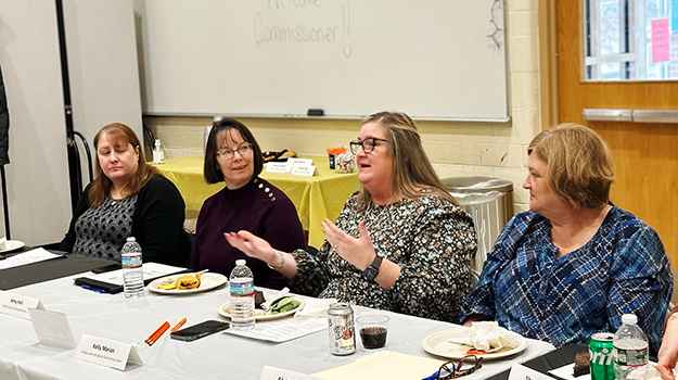 four women with one talking