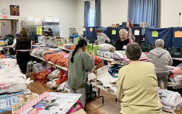 people pack bags of food