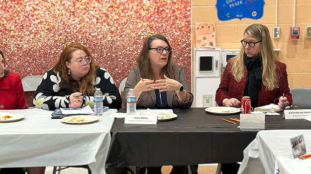 three women, middle woman talking