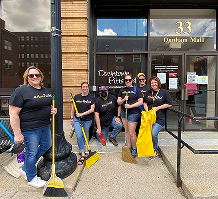 people line up with cleaning tools