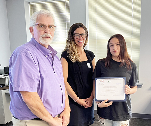 man, woman and young woman with certificate 