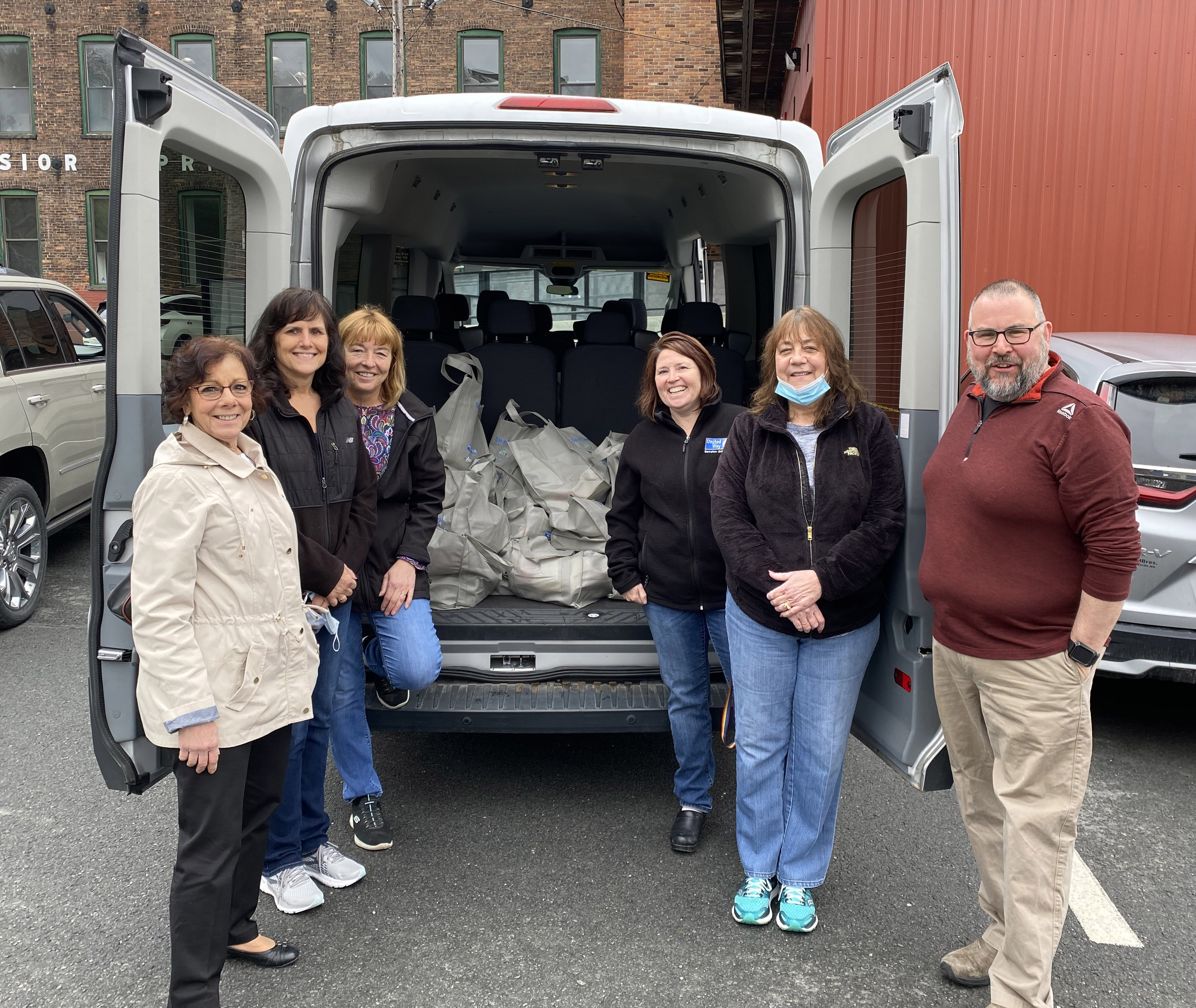 Patti Messina (NBUW), volunteers Michelle Sylvester and Aleta Moncecchi, Brenda Petell (BUW), volunteer Karen Labombard, and Tom Bernard (BUW) get ready to deliver bags on May 3