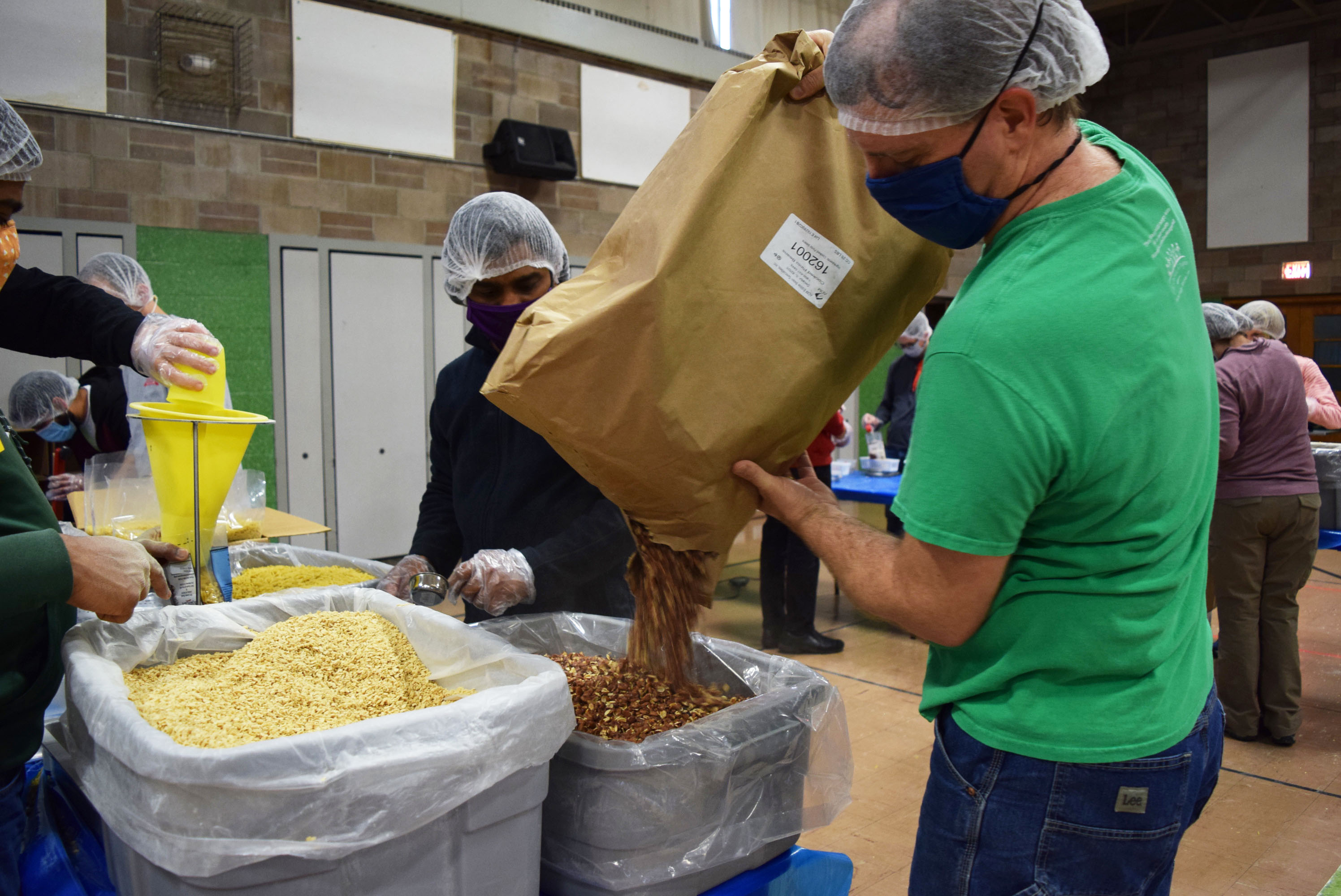 Matthew Martin of The Outreach Program refills food supply on April 17.