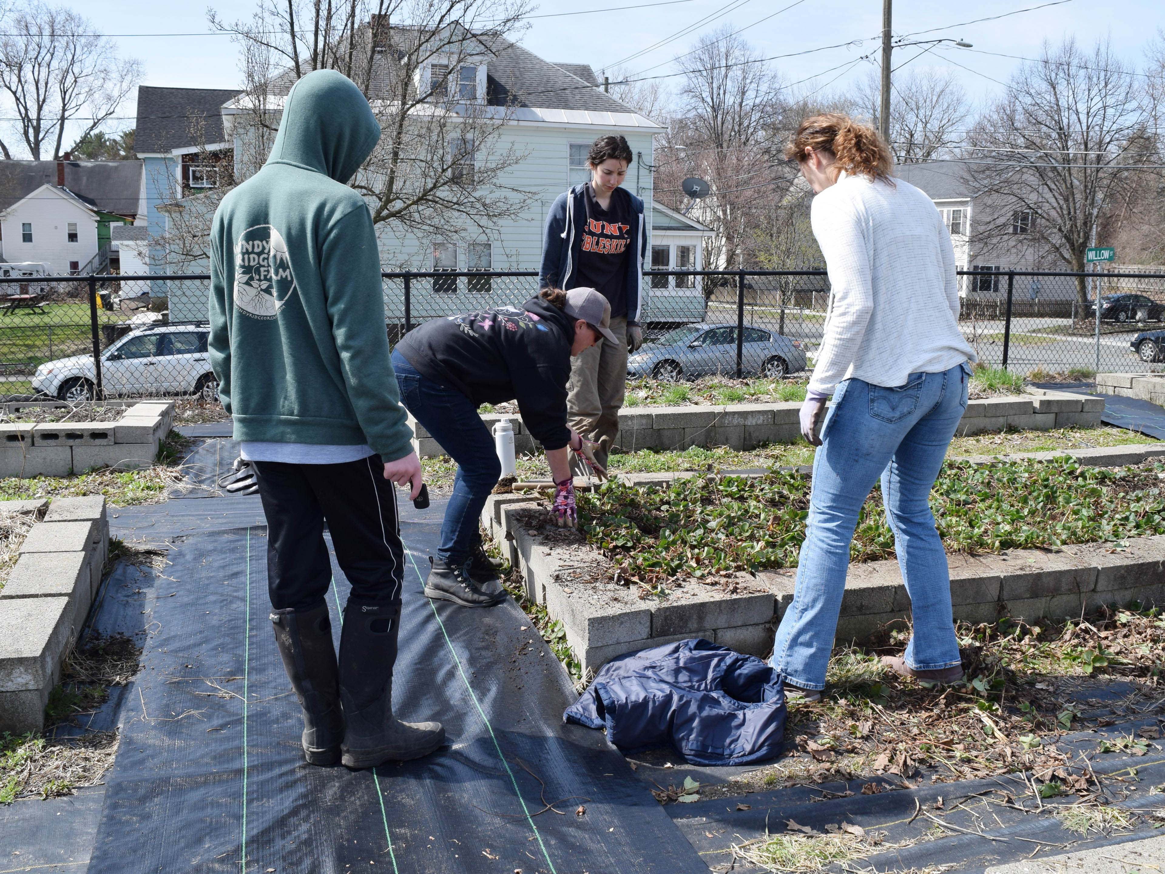 City gardener Julia Lemieux offers gardening instruction to some volunteers