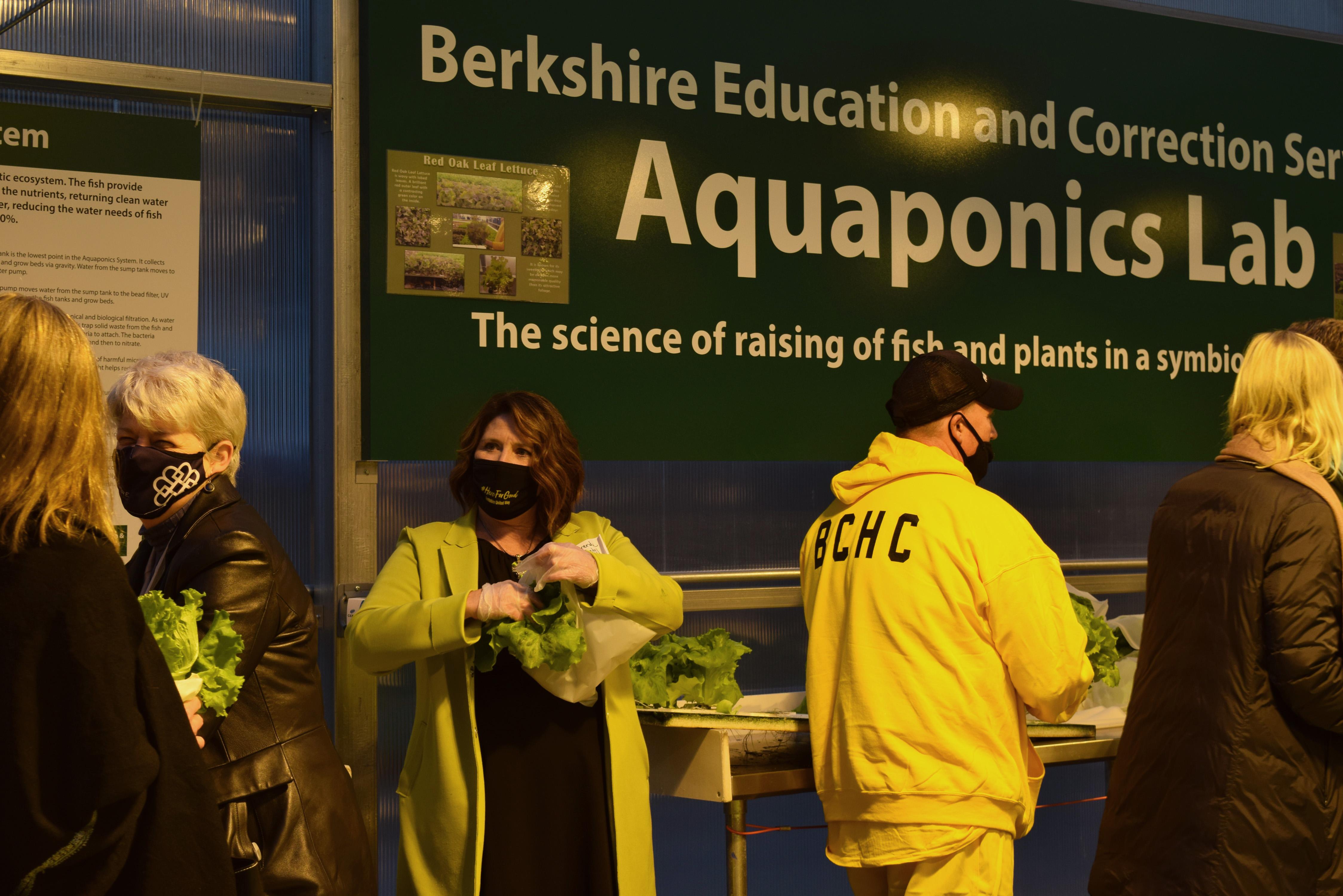 Brenda Petell hands out heads of lettuce