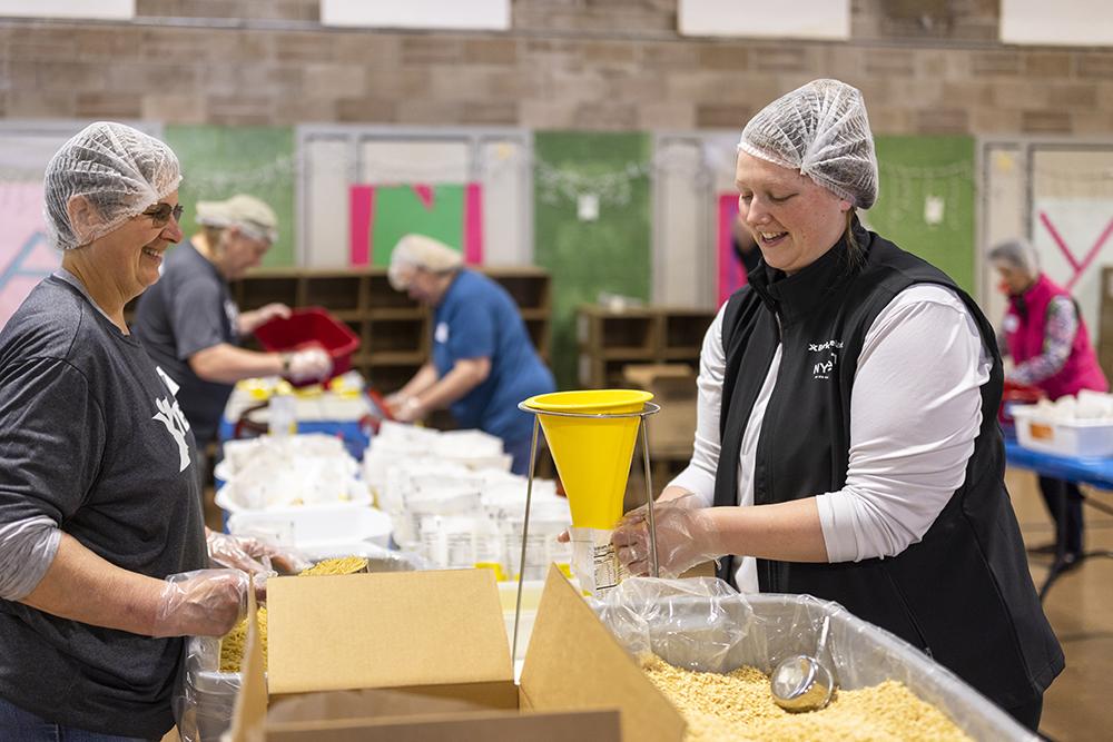 Berkshire Bank volunteers fill the mac n cheese bags