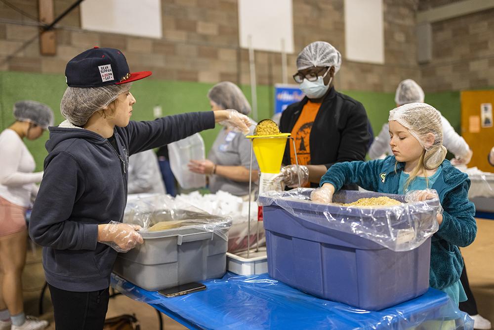 Volunteers of all ages helped out. Here, they pack the pasta with tomato basil sauce.