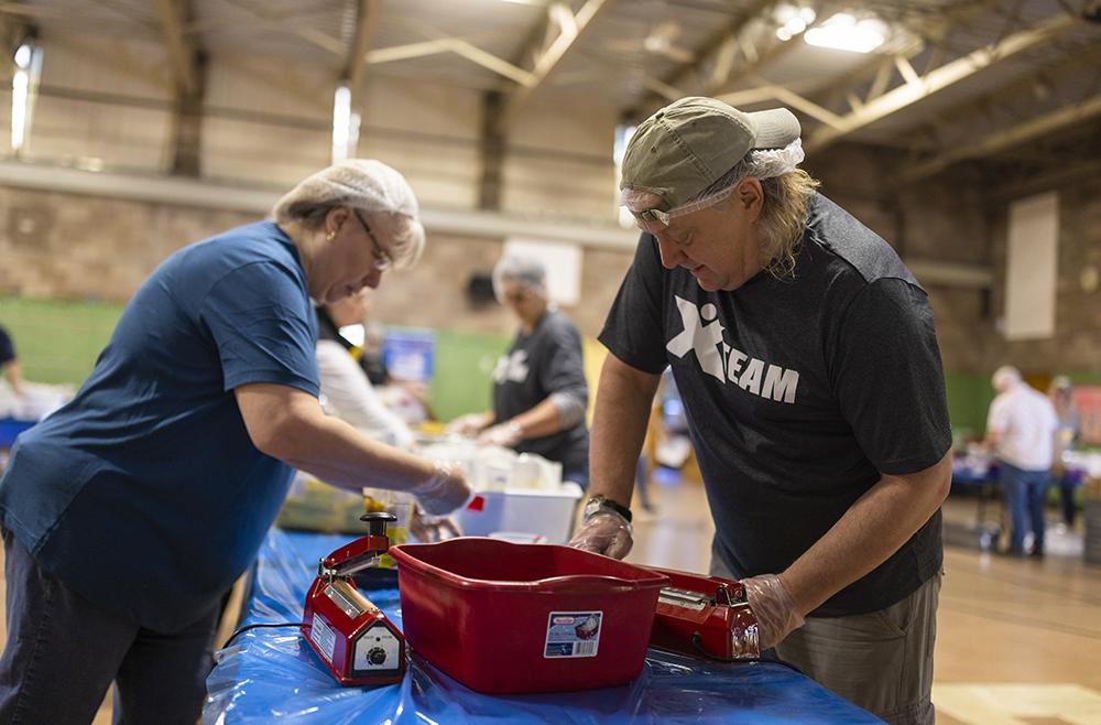 Other Berkshire Bank volunteers heat seal the bags