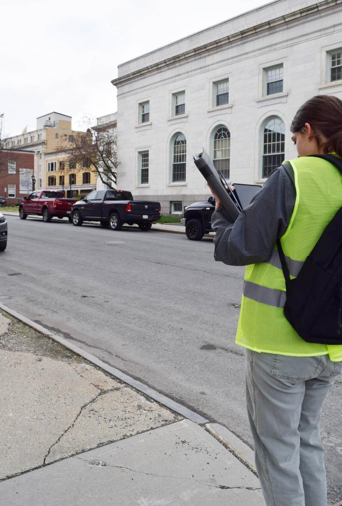 Another PHS student takes a photo of a sidewalk in disrepair