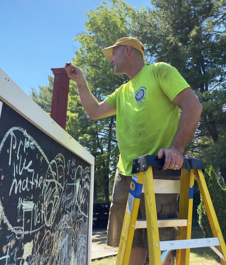 Erik Krutiak fixes the chalkboard