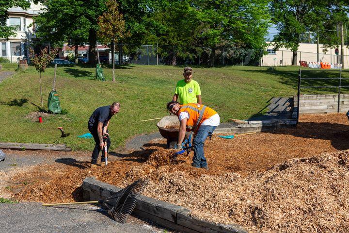 Adding new mulch to the playground