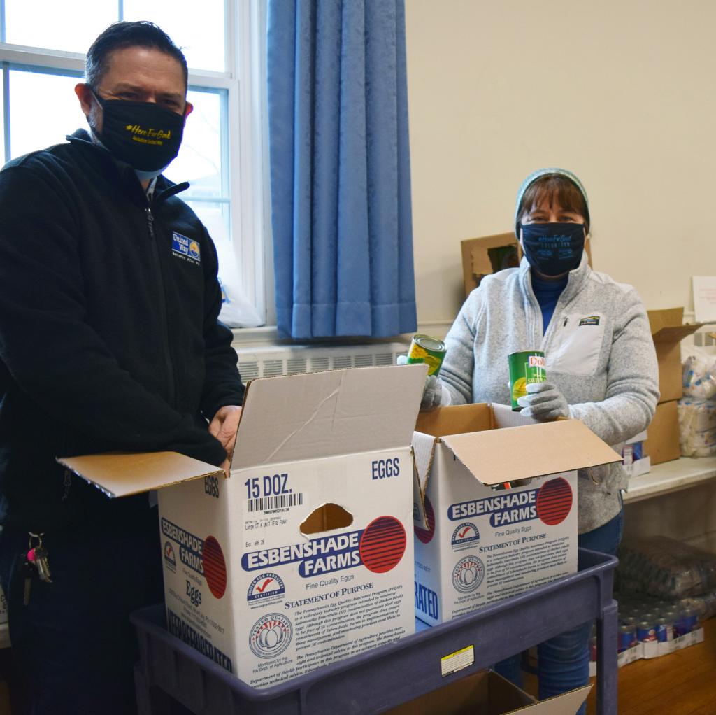 Robby O'Sullivan (BUW) and Rep. Tricia Farley-Bouvier at the South Congregational Church food pantry