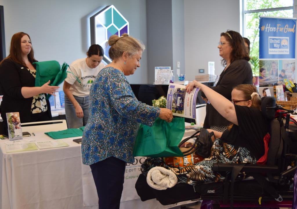 Liana Toscanini, executive director of the Nonprofit Center of the Berkshires, assists a community member