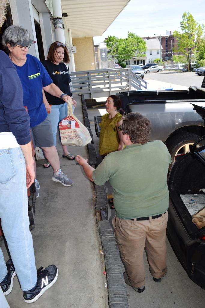 Roots & Dreams and Mustard Seeds founders Nicole Fecteau and Michael Hitchcock pick up food