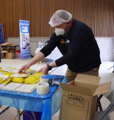 BUW's Tom Bernard packs the mac n cheese boxes