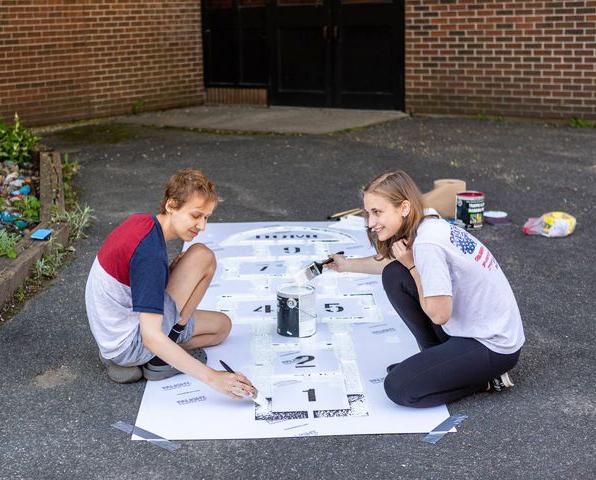 Zach Morin and Chelsi Krutiak, Hoosac Valley High School students, paint new hopscotch games