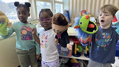 3 kids play with hand puppets